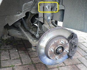 Tyre rub on the shock absorber, where an over-sized tyre had been fitted.